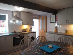 a kitchen with a table and chairs and a kitchen with a stove at Happy Days in Whitby