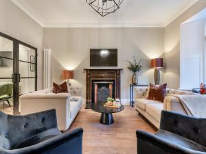 a living room with two couches and a fireplace at Old Bank House in Barnard Castle