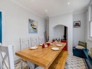 ein Esszimmer mit einem Holztisch und einem Sofa in der Unterkunft The Pantiles in Chesterfield