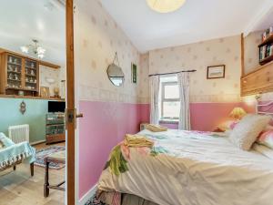 a bedroom with a large bed and a window at The Bothy - Uk37414 in Bunessan