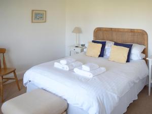 ein Schlafzimmer mit einem weißen Bett mit Handtüchern darauf in der Unterkunft Stonehanger 1 - Cottage in Salcombe