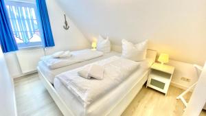 En eller flere senge i et værelse på Ferienhaus MAGELLAN '2'