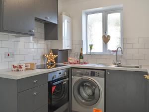 a kitchen with a washing machine and a sink at Apartment 2 - Uk42623 in Poole