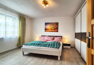 a bedroom with a bed and a painting on the wall at Almliesl TROF-760 in Trofaiach