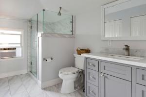 a bathroom with a toilet and a glass shower at Blueground Centennial BBQ nr Red Morton Park SFO-1856 in Redwood City