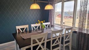 a dining room with a table and chairs and a window at Annexet 1 & 2 in Fränsta