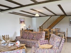 a living room with a couch and a table at Bay - E4482 in Ludham