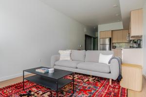 a living room with a couch and a table at Blueground Downtown rooftop nr Marymoor Park SEA-890 in Redmond