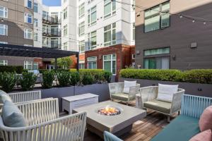 a patio with a table and chairs and a fire pit at Blueground Downtown rooftop nr Marymoor Park SEA-890 in Redmond