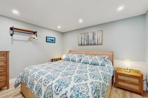 a bedroom with a bed with a blue and white bedspread at The Big Nest in Broadalbin