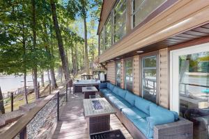a porch with a blue couch on a building at The Big Nest in Broadalbin