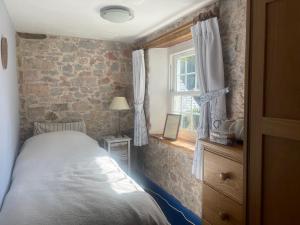 a bedroom with a bed and a window at Appalachian Spring B&B in Dartington +5 photos