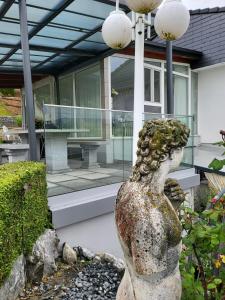 a statue of a woman in front of a house at 5,5 pc apartment, garden but Pool only upon request in Avry