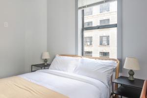 a bedroom with a white bed and a window at Blueground Midtown West wd nr Central Park NYC-1996 in New York