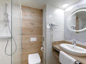 a bathroom with a sink and a shower at ibis Styles Kiel City in Kiel