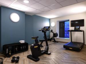 a fitness room with a treadmill and a gym at ibis Styles Kiel City in Kiel