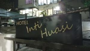 a sign in front of a hotel in a building at Hotel inti huasi in Villa Carlos Paz +3 photos
