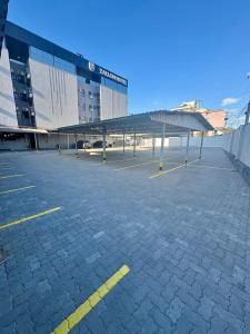 a parking lot in front of a large building at Zallon Hotel Executivo - Late Checkout Cortesia as 15hs aos DOMINGOS in Lajeado