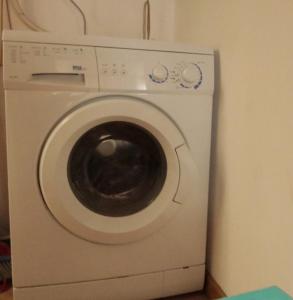 a white washing machine sitting in a room at Biker house in Ronciglione