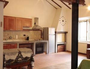 a kitchen with a refrigerator and a counter top at Biker house in Ronciglione
