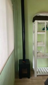 a room with a stove in a room with a bunk bed at La Herminda Casas de Campo in Nono