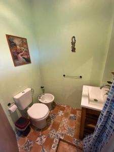 a bathroom with a toilet and a sink at La Herminda Casas de Campo in Nono +10 photos