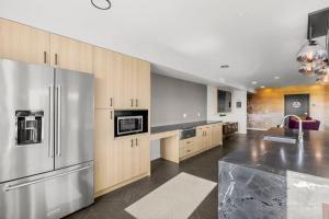 a kitchen with stainless steel appliances and wooden cabinets at Blueground Meridian Park rooftop BBQ nr Park SEA-933 in Shoreline +25 photos