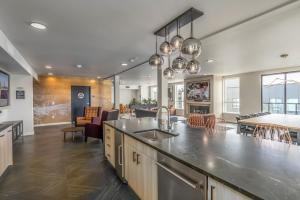 a kitchen and living room with a large counter top at Blueground Meridian Park rooftop BBQ nr Park SEA-933 in Shoreline