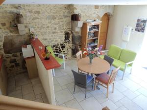 a kitchen and dining room with a table and chairs at Les Stiers in Chancé