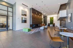 a lobby with tables and chairs and a fireplace at Blueground Brighton fitness center nr Park SEA-876 in Seattle