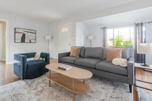 a living room with a couch and a chair at Blueground Centennial BBQ nr Red Morton Park SFO-1855 in Redwood City