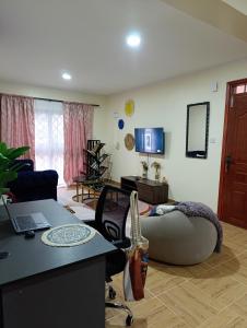 a living room with a large bean bag couch at Casa Aura Stays Kerugoya in Keruguya