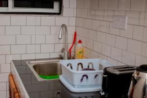 a kitchen counter with a sink and a sink at Reza stays apartment -Makumbusho behind Mwanga Tower in Dar es Salaam