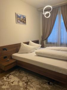 a bedroom with two beds and a window at Apartman ANDJELIJA 3 in Bački Brestovac