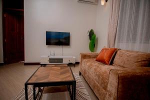 a living room with a couch and a table at Reza stays apartment -Makumbusho behind Mwanga Tower in Dar es Salaam