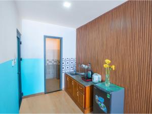 a bathroom with a vase of flowers on a counter at BOO Hostel , By the Beach in Da Nang