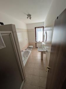 a bathroom with a tub and a toilet and a sink at La Finestra Sul Castello in Soave +26 photos