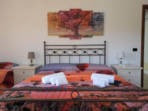 a bedroom with a bed with two pillows on it at La Finestra Sul Castello in Soave