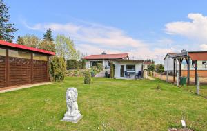 une cour avec une statue en face d'une maison dans l'établissement Ferienhaus Waren Müritz, à Warenshof
