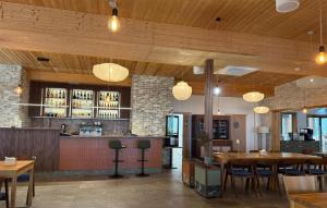 a restaurant with tables and chairs and a bar at 1 Bedroom Cozy Apartment In Okoniny Nadjeziorne in Okoniny Nadjezierne