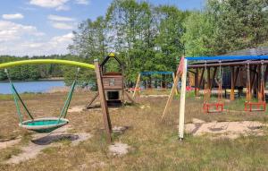 an empty playground with swings at 1 Bedroom Cozy Apartment In Okoniny Nadjeziorne in Okoniny Nadjezierne