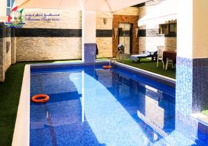 a large swimming pool with a blue tiled floor at Manama Tower Hotel in Manama