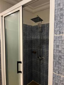 a shower with a glass door in a bathroom at IMMOloc in Libreville