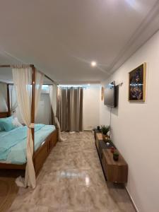 a bedroom with a bed and a tv in it at IMMOloc in Libreville