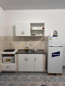 a kitchen with a sink and a refrigerator at Apartment on Av San Jose 2 in Ciudad del Este