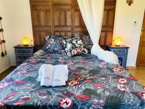 a bed with two towels on it with two lamps at Villa Jina con piscina by At Home Costa del Sol in Torrox +76 photos