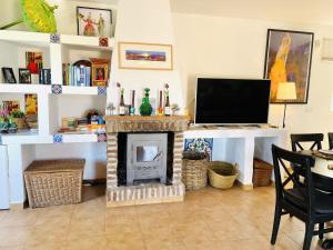 a living room with a fireplace and a television at Villa Jina con piscina by At Home Costa del Sol in Torrox