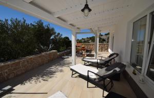 un porche con 2 sillas y una mesa. en Ferienhaus Katarina by Villas Guide, en Šarići