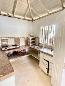 a kitchen with a sink and a counter top at LAKE HOUSE - La maison VEDA in Habaraduwa