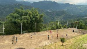 a group of people playing a game of soccer on a hill at Finca el porvenir in Sasaima